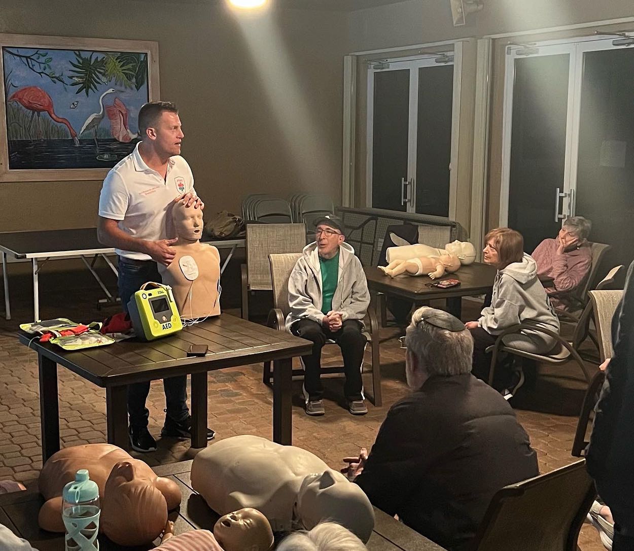 JVAC instructor demonstrating CPR and AED use to community members