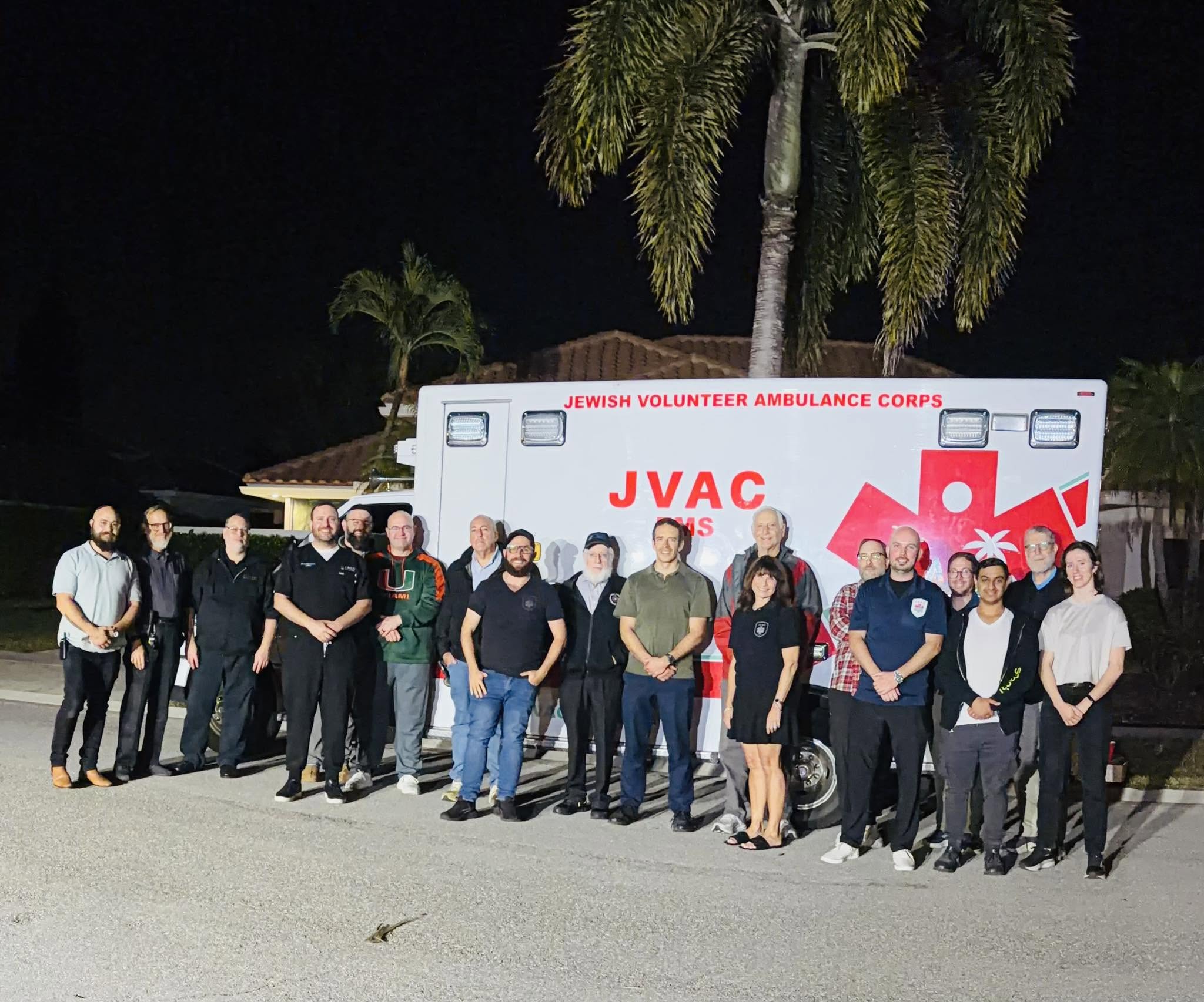 JVAC volunteers gathered in front of an ambulance at night